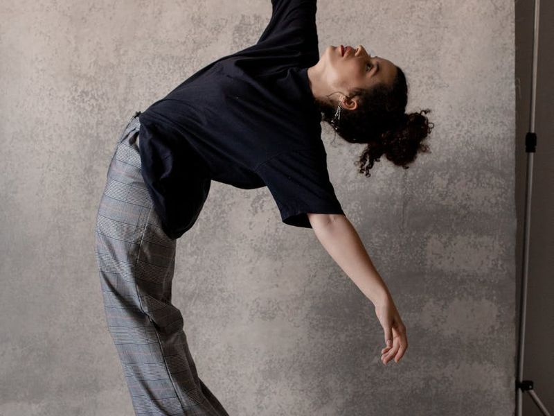 Person in a dynamic yoga pose, captured in motion.